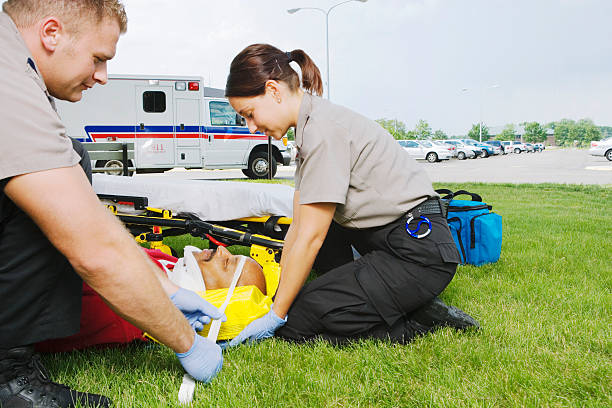 istock Paramedics attaching neck brace to patient on grass 526235529