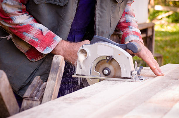 istock Man cutting wood with circular saw 526236911
