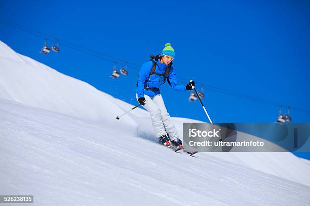 Mid Adult Women Snow Skier Skiing On Sunny Ski Resorts Stock Photo - Download Image Now