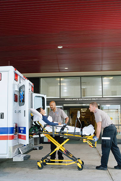 istock Paramedics removing patient on stretcher from ambulance 526239059