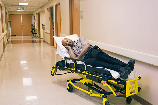Empty medical stretcher bed in hospital corridor. Emergency room gurney. Modern transport equipment for patient care.