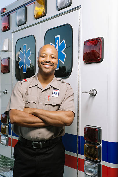 istock Paramedic in front of ambulance, portrait 526239079