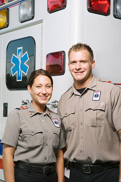 istock Two paramedics in front of ambulance, portrait 526239083