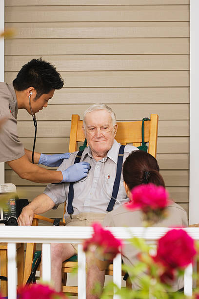 istock Two paramedics examining senior man on porch 526239251