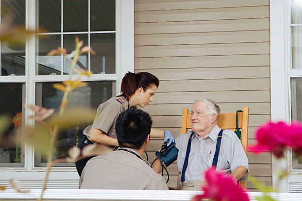 istock Paramedics examining senior man on porch 526239253
