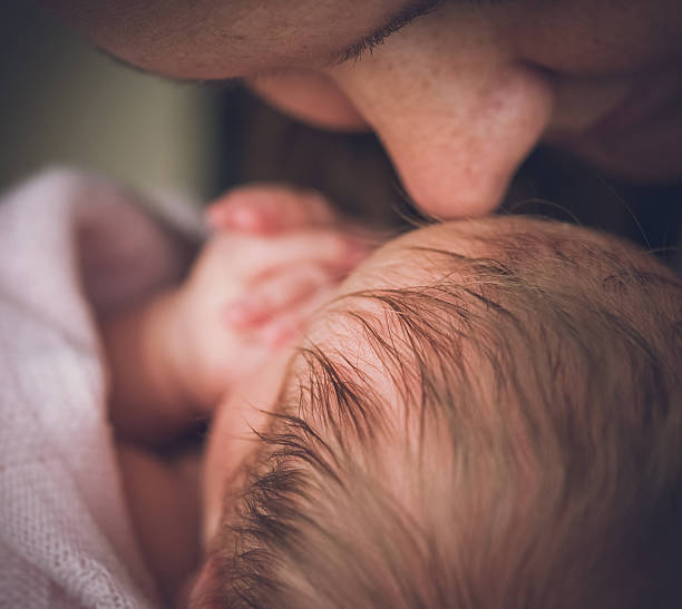 istock Mother and her sleeping newborn baby 526239497