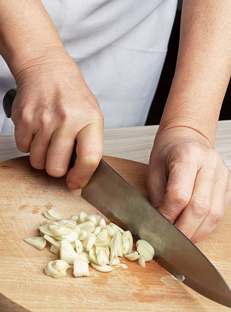 istock Woman chopping the garlic with knife. 526244657