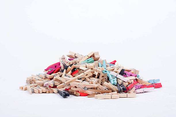 istock Colorful wood pegs pins on white background 526245779
