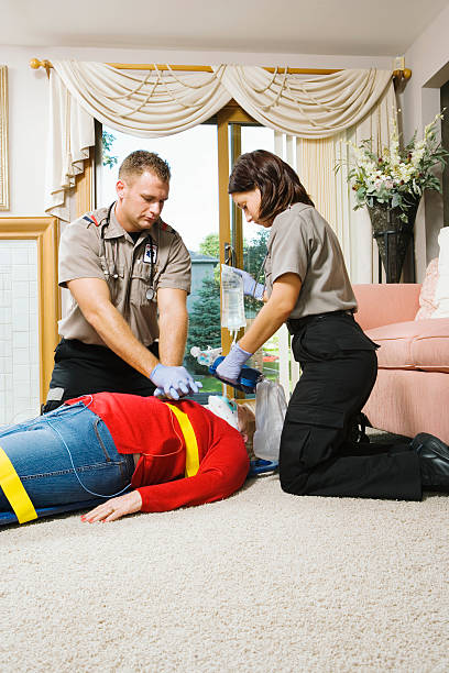 istock Two paramedics administering CPR to senior patient on floor 526248585