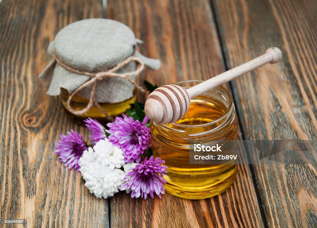 honey Fresh glass pot of sweet honey with flowers on wooden background Breakfast Stock Photo