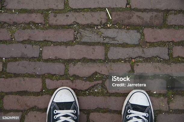 Black Canvas Sneakers Brick Street Stock Photo - Download Image Now - Baseball Shoe, Black Color, Brick