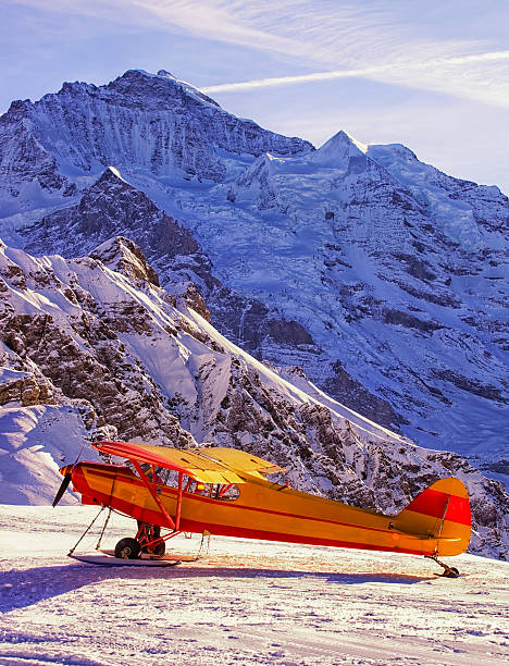 istock Yellow red airplane at the mountain airfield 526250379