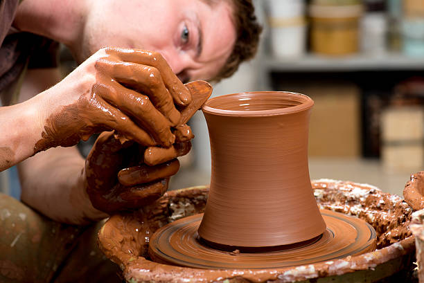 istock hands of a potter, creating an earthen jar 526251803
