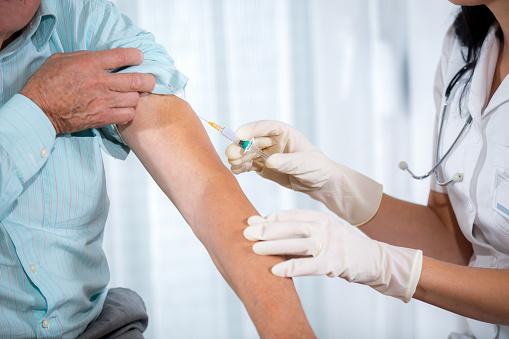 Nurse giving man vaccination