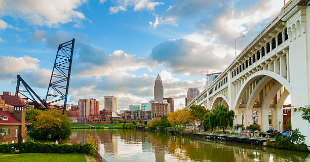 Cleveland waterfront The Cuyahoga River bends past downtown Cleveland by the Veterans Memorial Bridge with old lift bridge at left cuyahoga river photos stock pictures, royalty-free photos & images