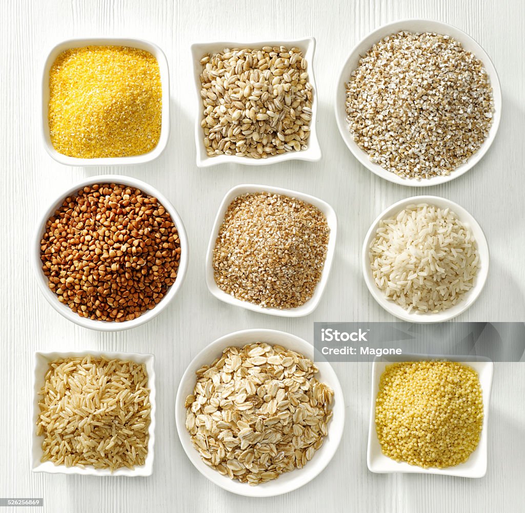 various types of cereal grains various kinds of cereal grains on white wooden table Avena Stock Photo