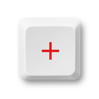 Addition red symbol on a white computer key isolated on white. Key's clipping path included. The red color of the plus sign can be easily modified in photoshop by moving the Hue/Saturation slider without affecting the rest of the image. 
