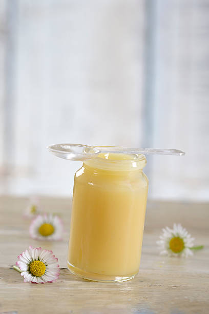 raw organic royal jelly in a small bottle stock photo