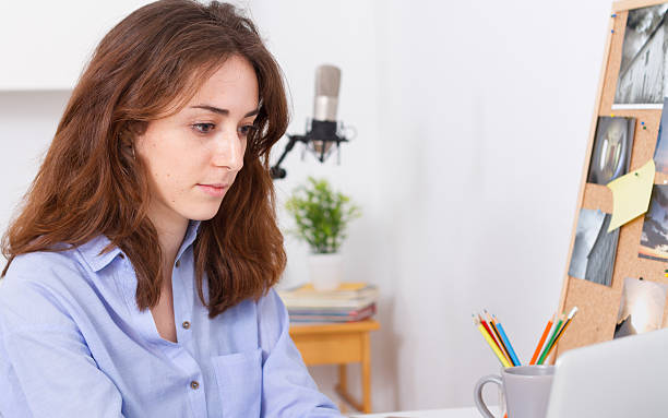 istock Young blogger working with laptop in her workspace 526269555