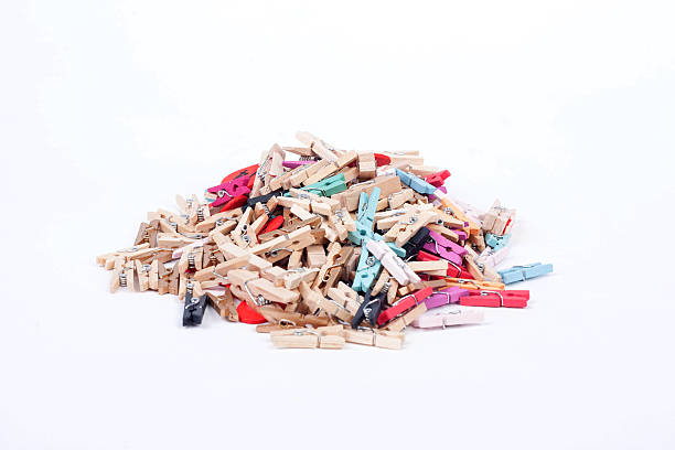 istock Colorful wood pegs pins on white background 526269969