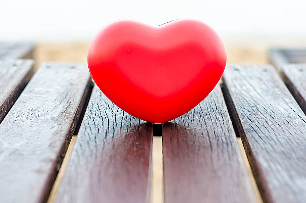 istock red hearts on the wood table in the beach symbolizing love 526270015