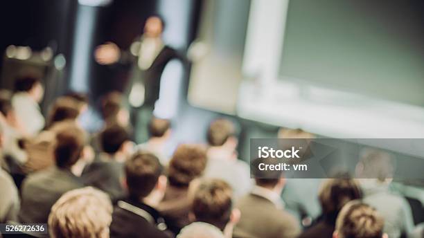 Large Group Of People Listening To A Presentation Stock Photo - Download Image Now - Seminar, Lecture Hall, Presentation - Speech