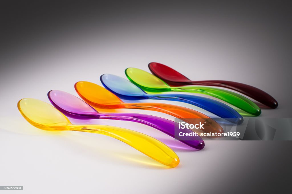 Colored plastic spoons Colorful plastic spoons on white background Arrangement Stock Photo