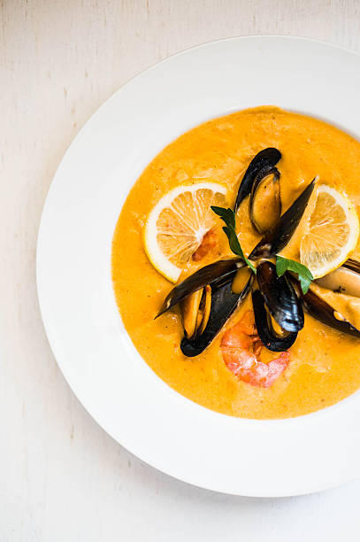 istock Shrimp soup with mussels on white background 526273346