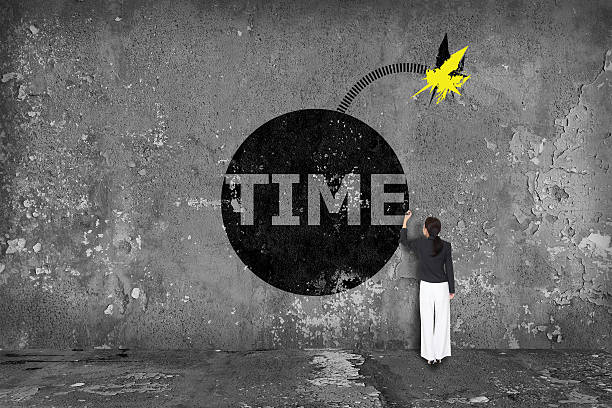 istock businesswoman drawing grenade time on the wall 526274097
