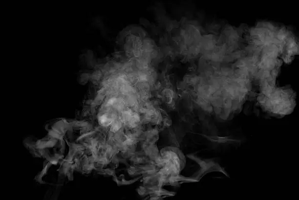 Smoke swirling around against a black backgroundSmoke swirling around against a black background