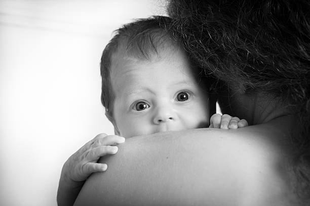 Baby girl in father's arms stock photo
