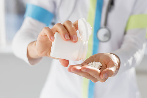 istock Doctor pouring medicine pills in hand 526274809