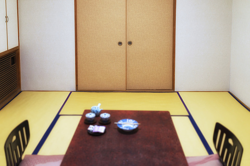 A traditional Japanese living room with table and seats.