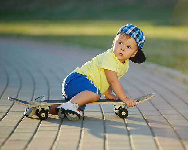 istock cute little boy with skateboard outdoors 526282344