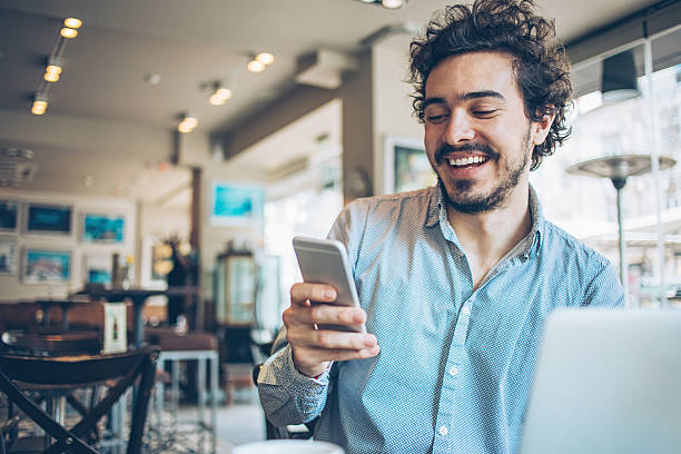 istock Man with phone and laptop in restaurant 526282388