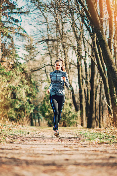 ランニング公園で - running track women running spring ストックフォトと画像