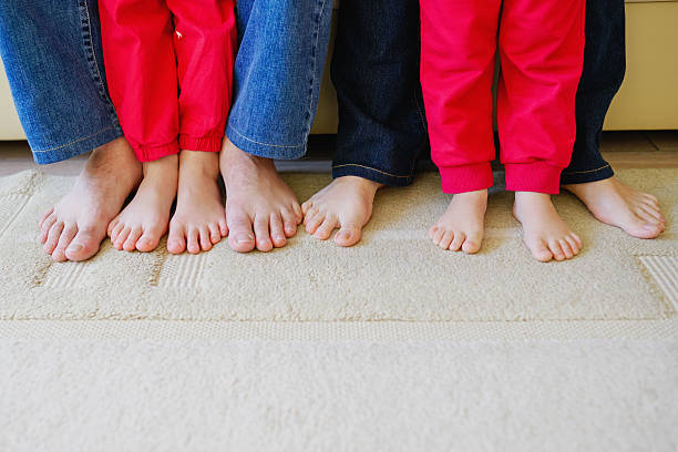 istock barefoot family feet at home 526284212