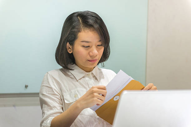 istock Asian businesswoman checking information on sales reports 526284872