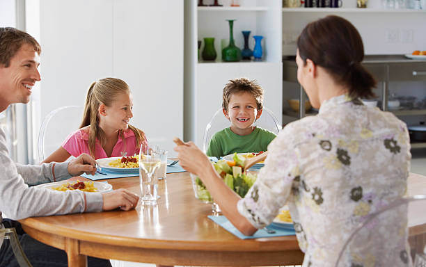 istock Family Enjoying Meal At Dining Table 526285081