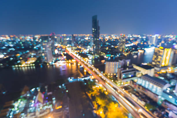 istock Aerial view, blurred bokeh lights night city and river curved 526285374