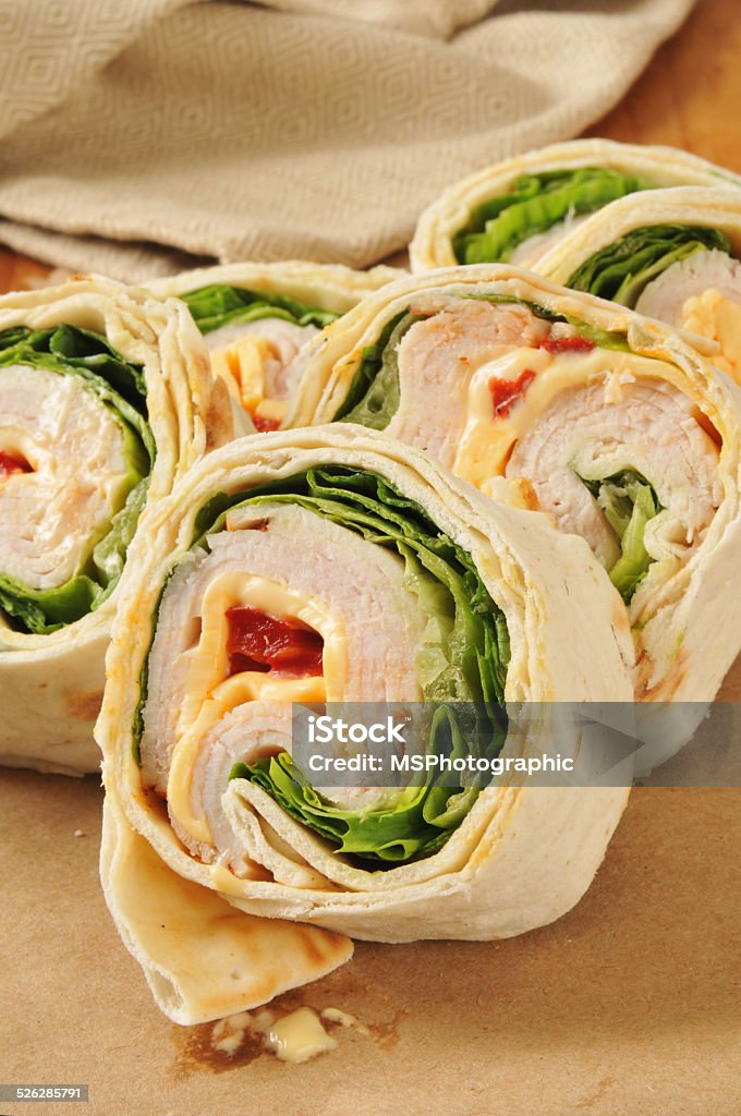 Turkey wrap sandwich A turkey wrap sandwich on brown wrapping paper Cheese Stock Photo