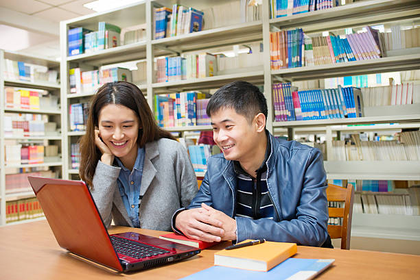istock Male and female students in the library 526288757