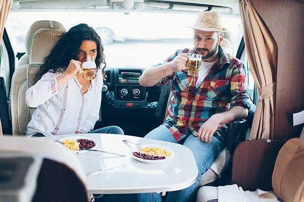 istock Young couple dining inside of a camper van 526288822