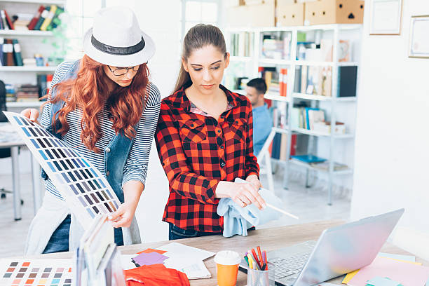 istock Young female designers holding a color swatch and working 526289242