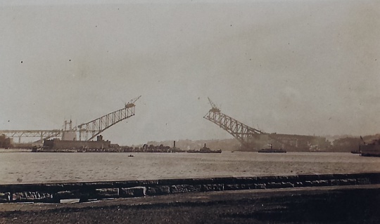 This picture was taken by my grandfather in 1929 while on holiday in Sydney, Australia. Construction of the Sydney Harbour Bridge commenced in 1923 and was completed in 1932. Also known locally as “the coat hanger” and simple “the bridge”, the Sydney Harbour Bridge carries rail, vehicle and pedestrian traffic between the Sydney central business district and the North Shore. The view of the bridge, harbour and nearby Sydney Opera House is now an iconic image of Sydney. The graininess of the photo only adds to the history, age and romance of this image.