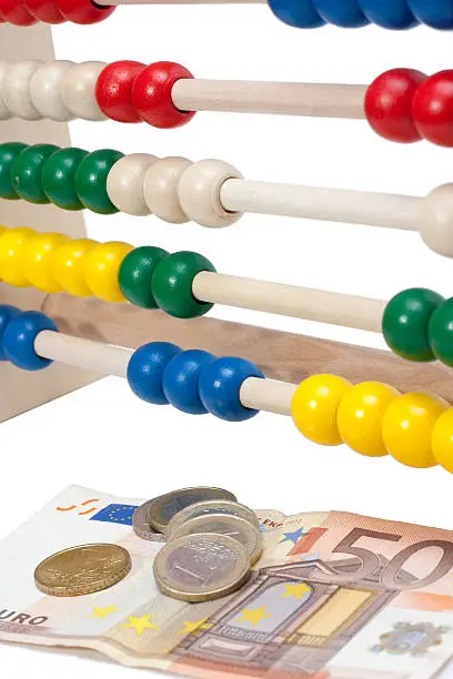 Close up of a colored children sliderule with money