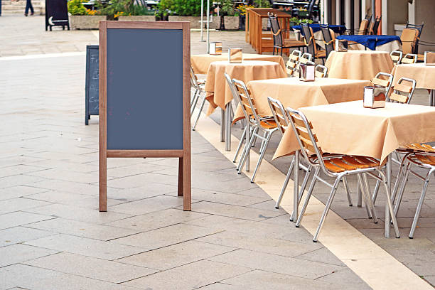 istock Blank sandwich board on sidewalk near cafe, copy space 526291498