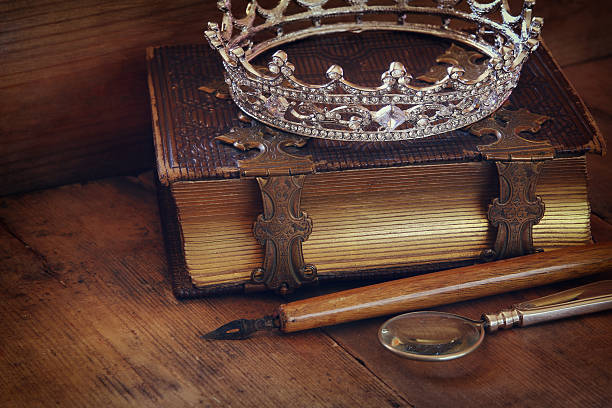 istock low key image of diamond queen crown on old book 526293520