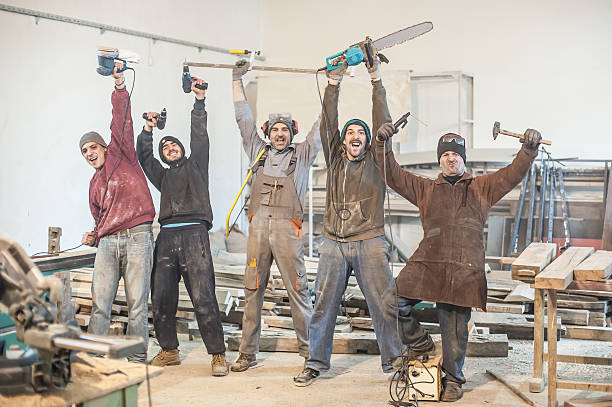Funny Workers Workers posing with their tools in the workshop power tool photos stock pictures, royalty-free photos & images