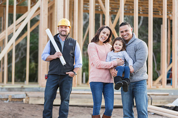 Hispanic family building a new home, with contractor